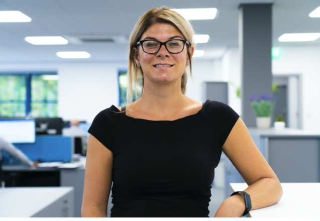 A woman in an office smiling