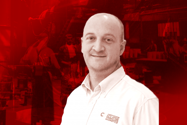 A man in an Eclipse Magnetics white shirt on a red background